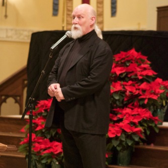Artistic Director and Conductor Timothy Waugh speaking to the audience at a December 2015 holiday concert.